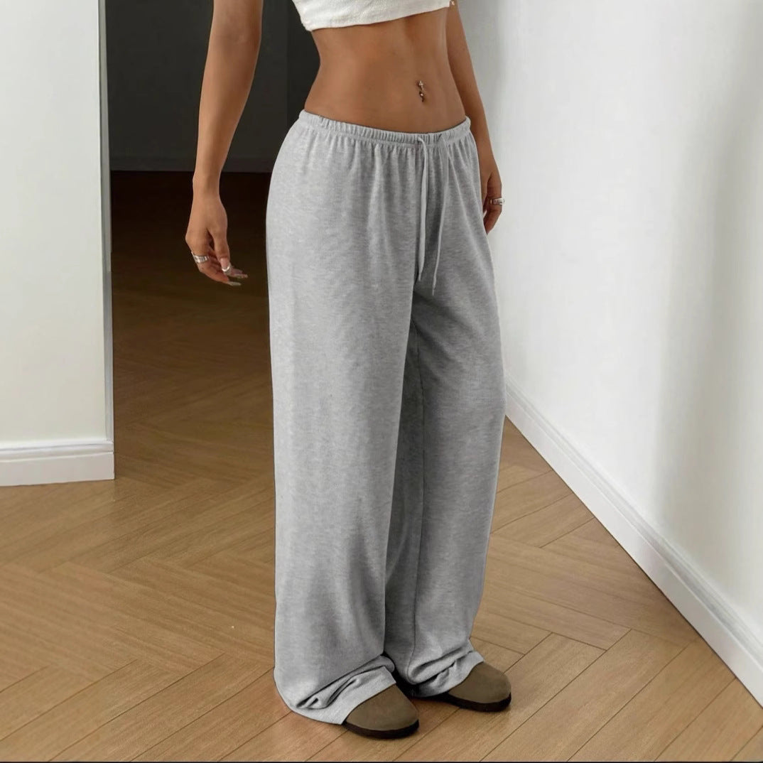 Gray wide-leg sweatpants with elastic waistband and drawstring, relaxed fit