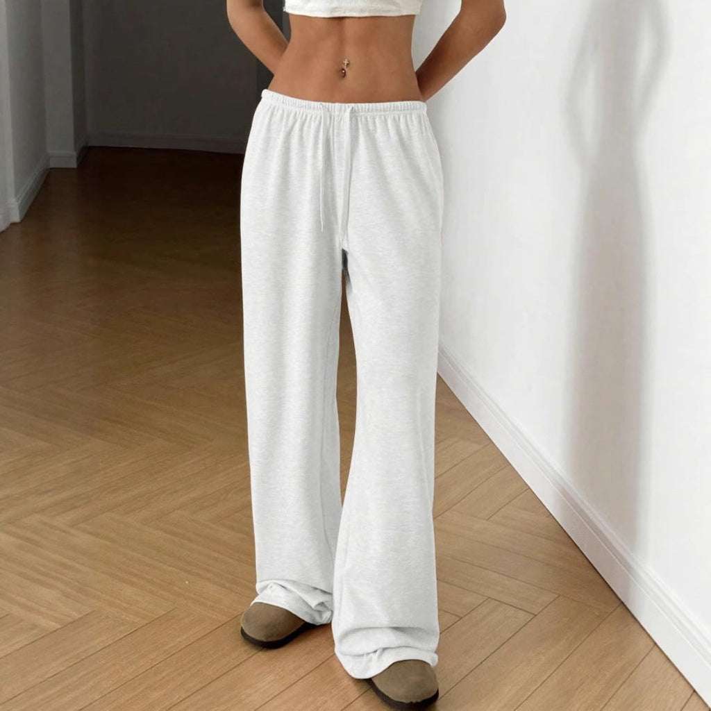 White wide-leg sweatpants with elastic waistband and drawstring, full length