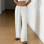 White wide-leg sweatpants with elastic waistband and drawstring, full length
