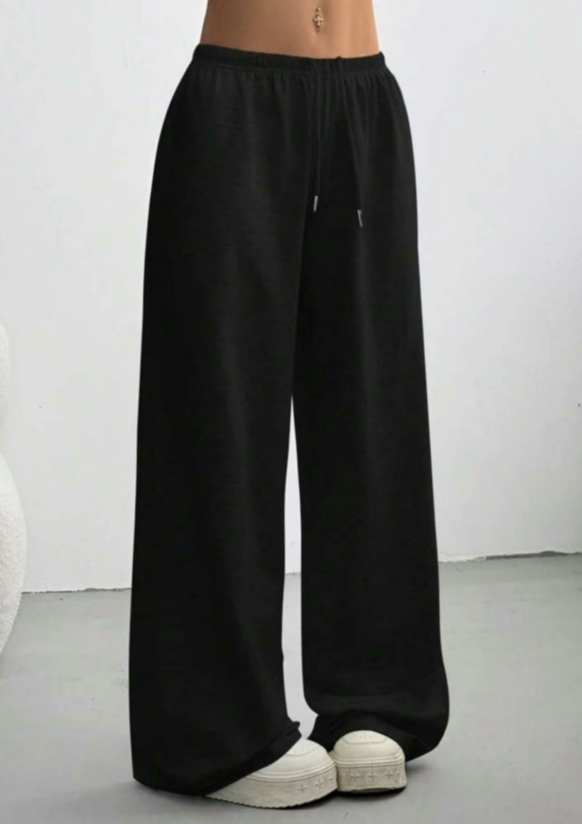 Black wide-leg sweatpants with elastic waistband and drawstring, long straight legs