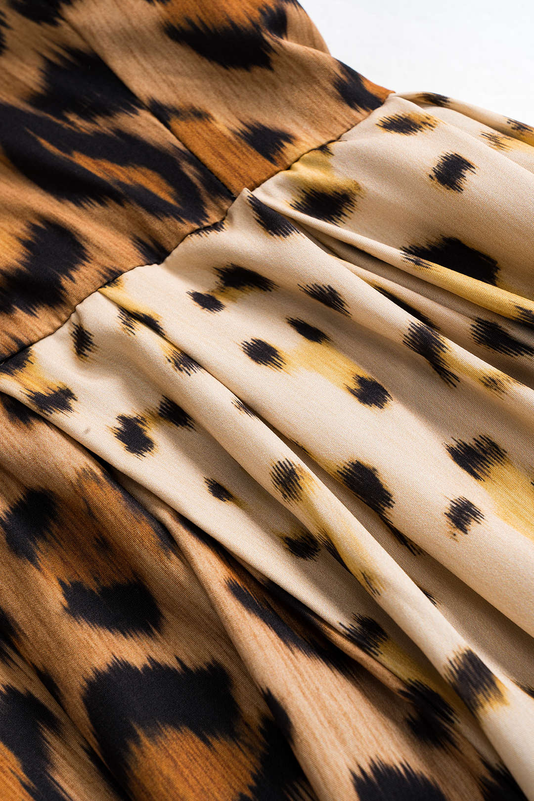 Leopard print fabric close-up in tan, black, and brown tones