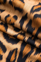 Leopard print woven fabric close-up with bold dark and tan stripes