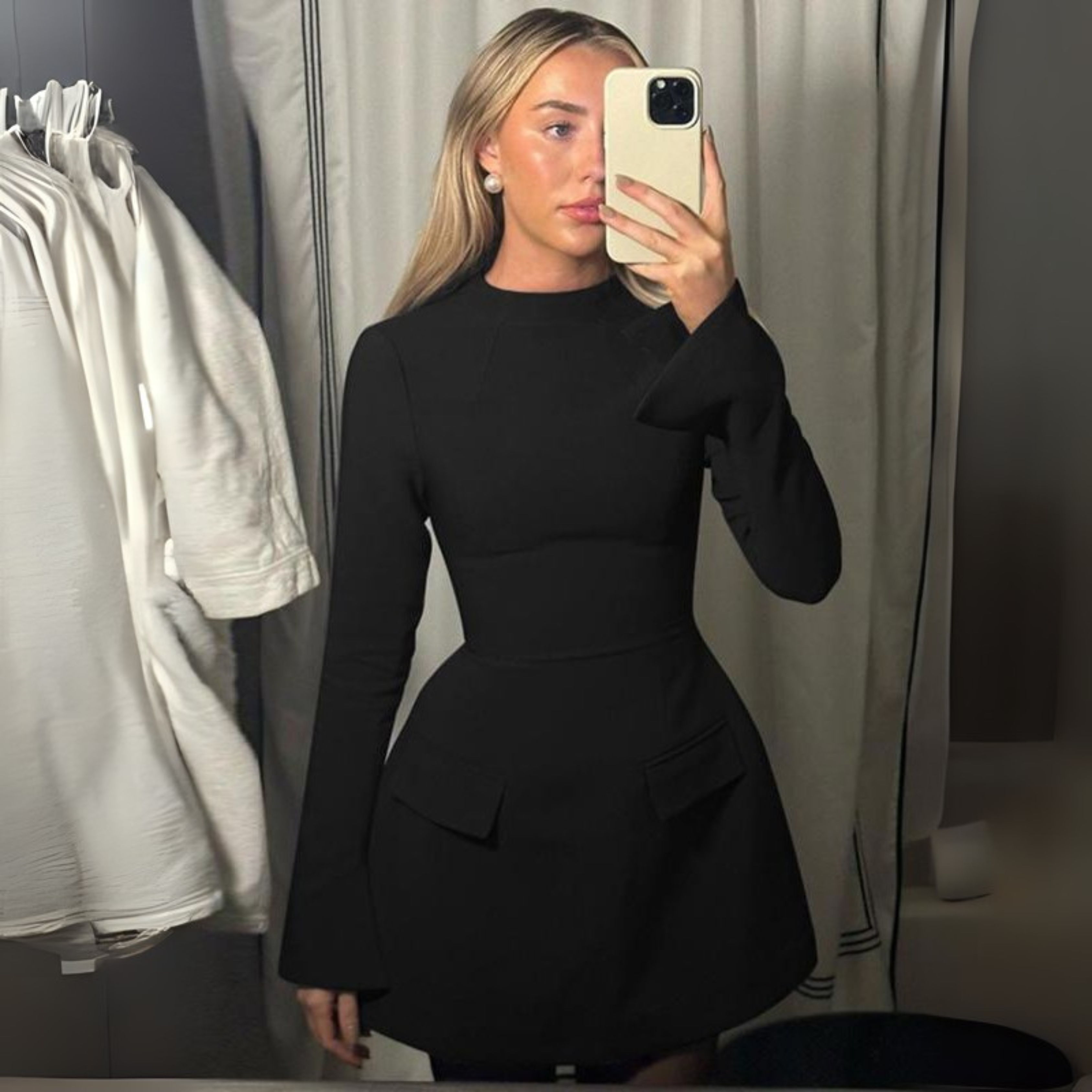 Black long-sleeve bodycon mini dress with high neck and flap pocket details