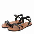 Women’s strappy flat sandals, open toe, black leather with two crisscross straps and buckle.