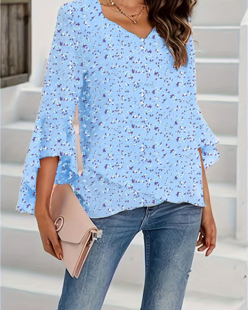 Light blue floral V-neck blouse with flared 3/4 bell sleeves and hip-length hem