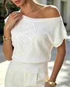 White knit one-shoulder top with embroidered daisy applique, short batwing sleeves