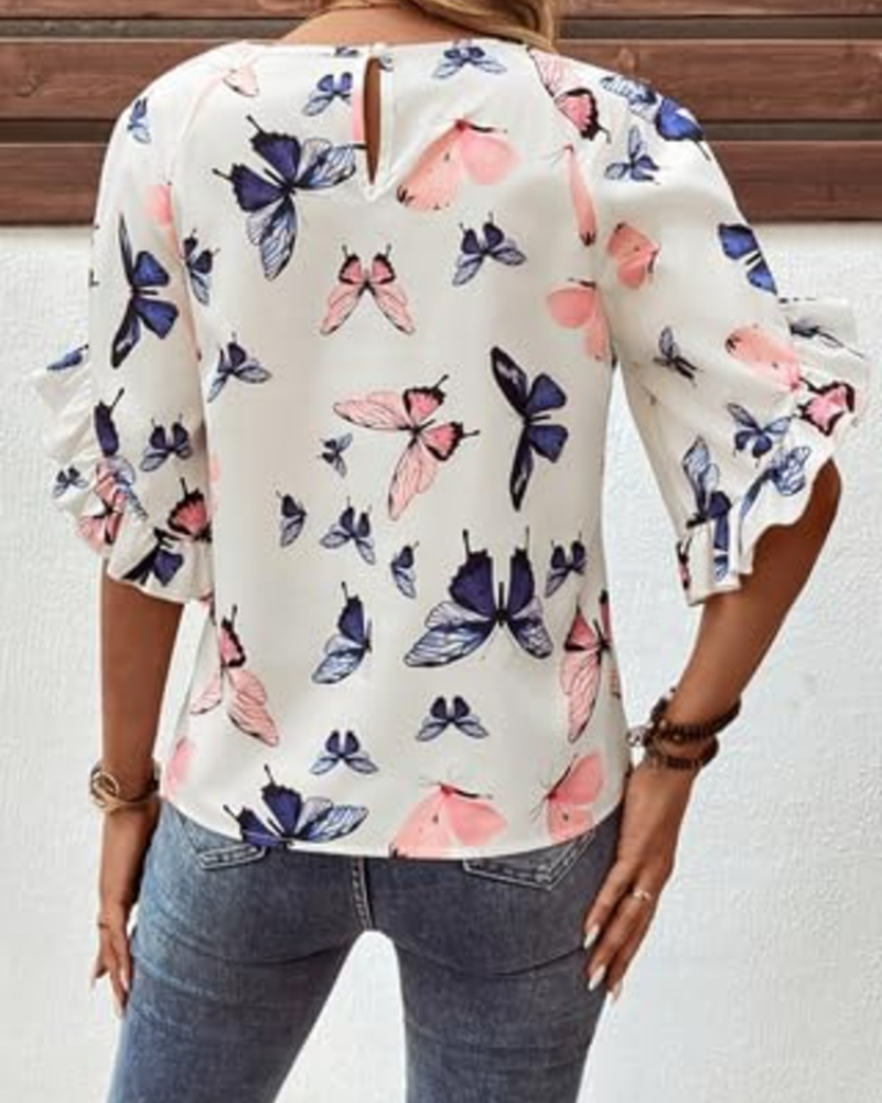 White floral butterfly print blouse, back view with loose fit and short ruffle sleeves