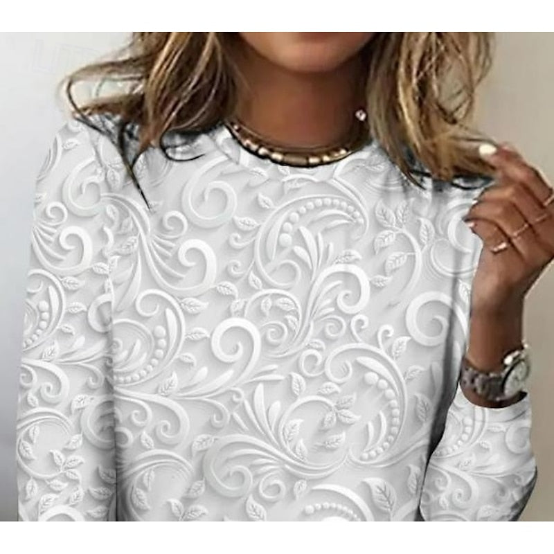 Pearl long-sleeve tunic close-up with embossed floral scroll pattern across chest