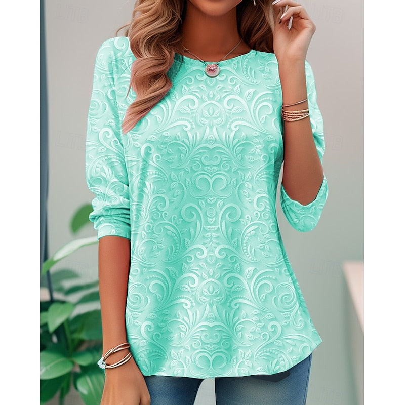 Green long-sleeve tunic with embossed floral scroll pattern and round neckline