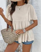 Beige round-neck peplum t-shirt with pearl trim at sleeves and hem