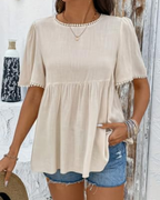Beige round-neck peplum t-shirt with textured fabric and pearl-trim sleeves