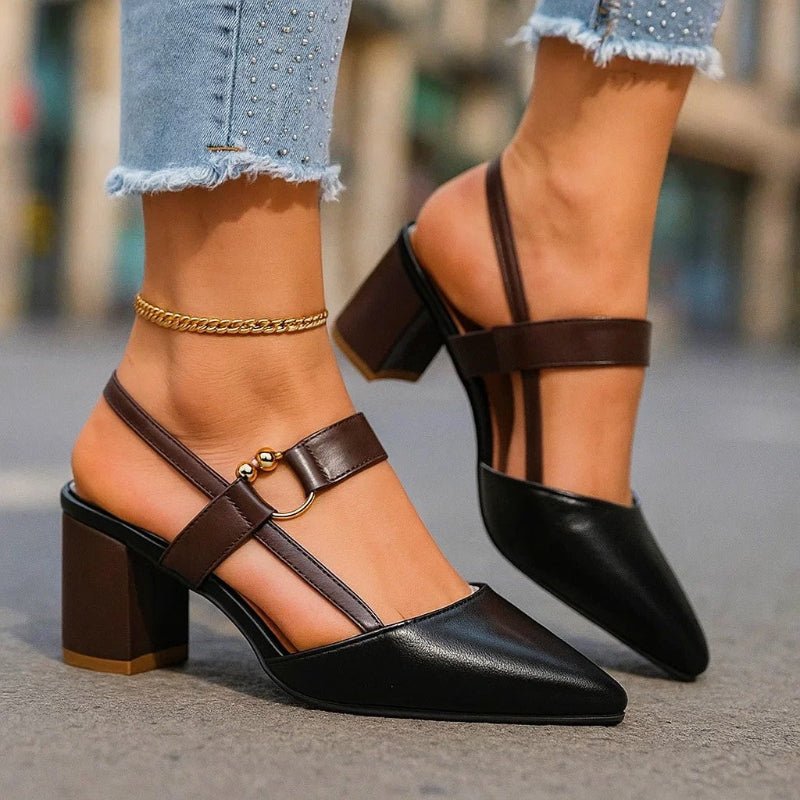 Black pointed-toe slingback heels with buckled ankle strap and block heel