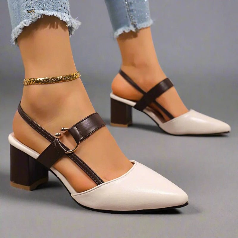 Beige pointed-toe slingback block heels with black buckle strap and block heel