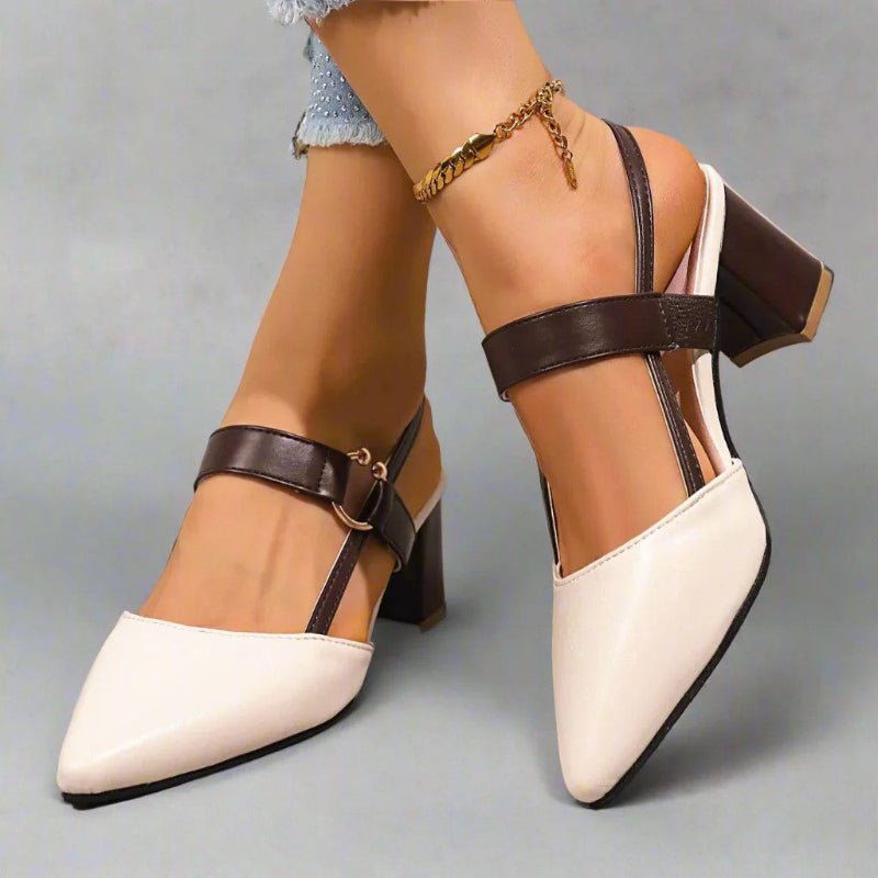 White slingback block heels with pointed toe, black buckle strap and block heel