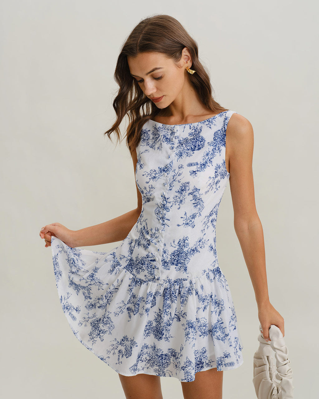 Floral print A-line mini dress with boat neck and sleeveless bodice, blue on white
