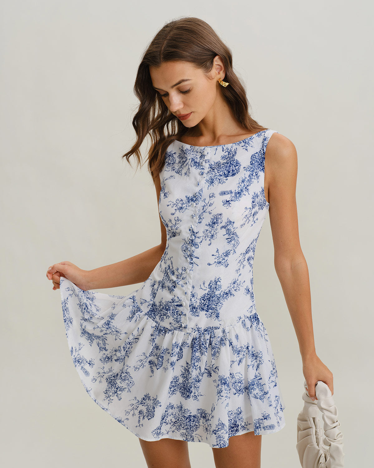 Floral print A-line mini dress with boat neck and sleeveless bodice, blue on white