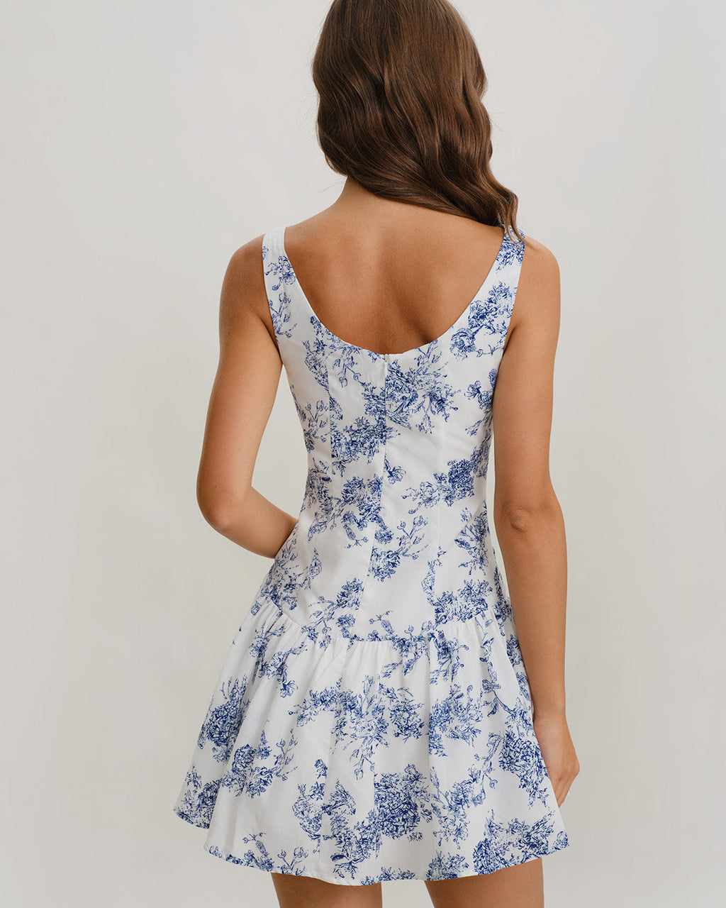 Back view floral print mini dress, sleeveless boat neck, blue pattern on white