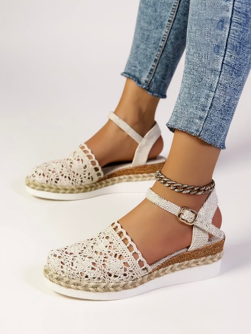 Beige crochet espadrille flatform sandals with ankle strap and woven jute midsole.