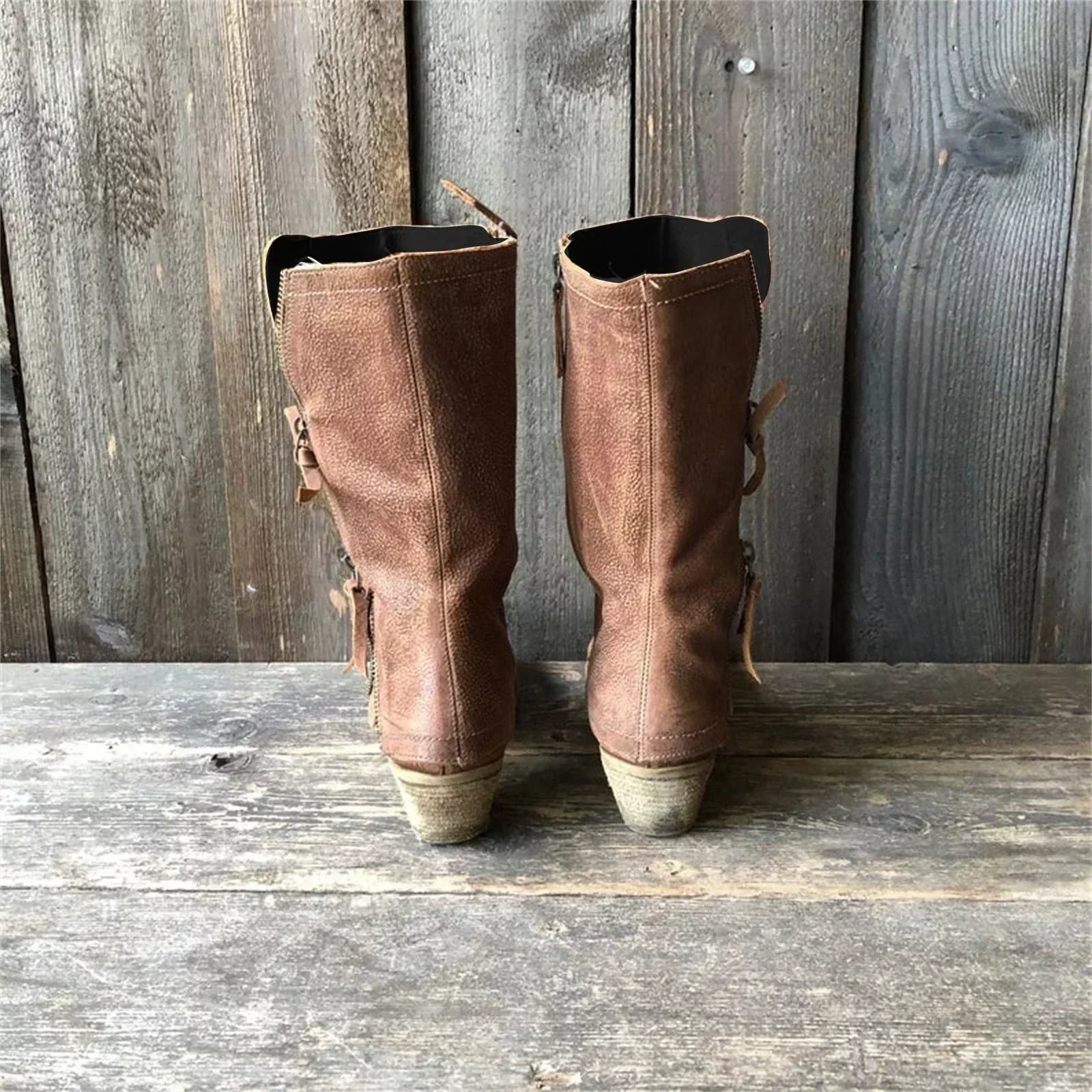 Back view of brown mid-calf side-zip boots with low stacked heels
