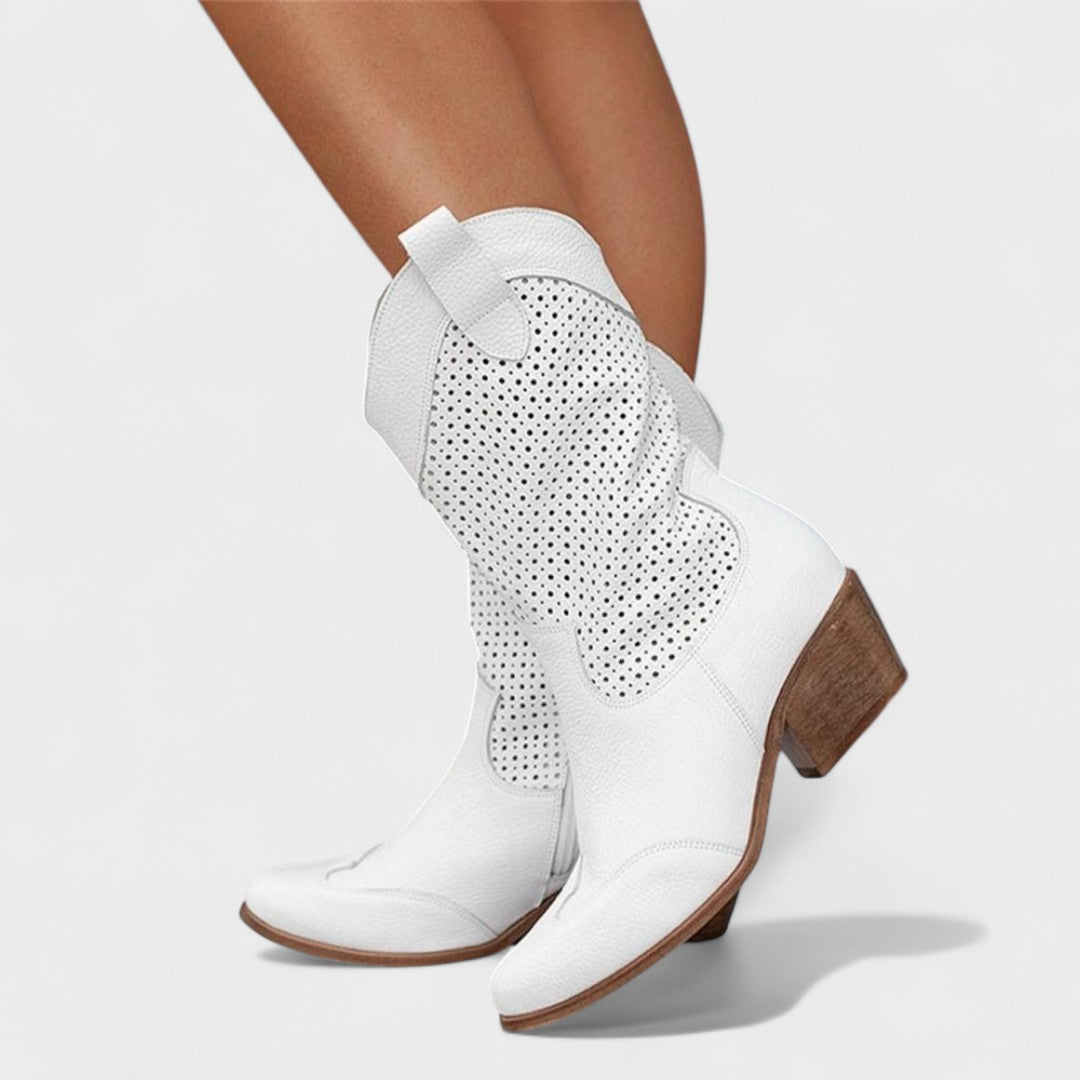 White mid-calf boots with perforated side panels and buckle strap detail