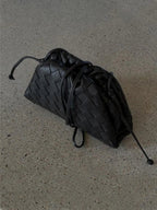 Black braided faux leather drawstring bag with cords and woven texture detail.