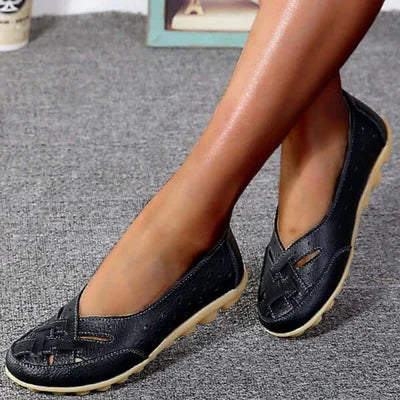 Black leather loafers with perforations and low cushioned outsole, slip-on