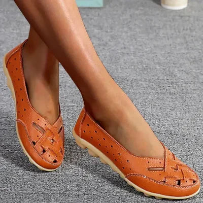 Orange leather loafers with perforated upper and stitched moc-toe detail, slip-on