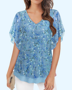Blue floral V-neck knit blouse with short ruffled sleeves and double-layer hem