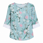 Blue-green floral print blouse with round neck and short sleeves, button front.