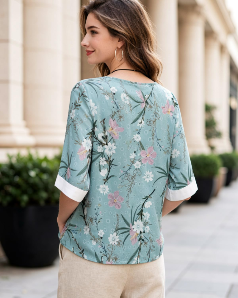 Lightweight floral blouse, back view with round neck and short sleeves, teal print