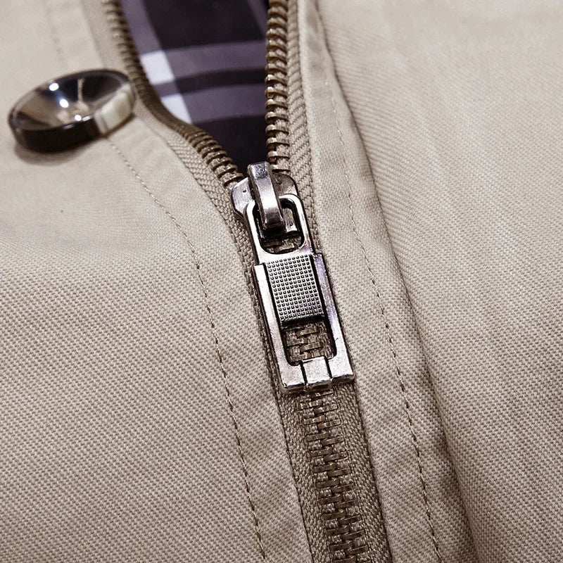 Beige hooded field coat close-up: metal zipper pull on the front placket.