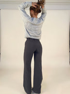 Black relaxed wide-leg trousers with high rise and wide, tapered-at-floor drape