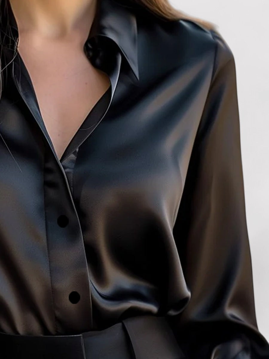 Black satin long-sleeve blouse close-up: pointed collar and button front