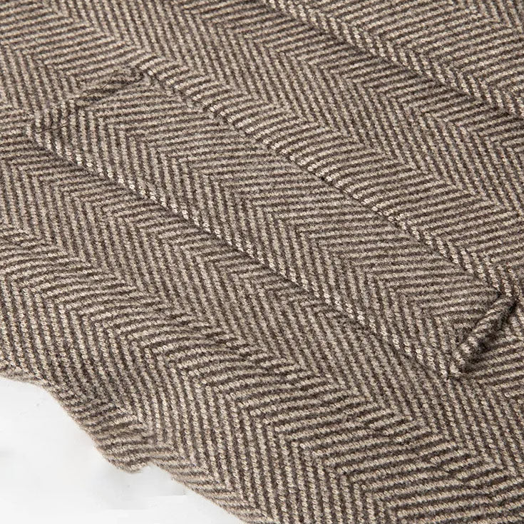 Khaki herringbone wool fabric close-up with textured weave