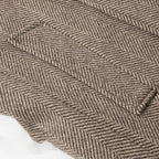 Khaki herringbone wool fabric close-up with textured weave