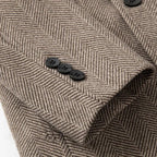 Khaki overcoat button detail on herringbone wool with overlapping placket