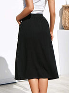 Black A-line skirt with button front and elastic waistband, mid-calf length