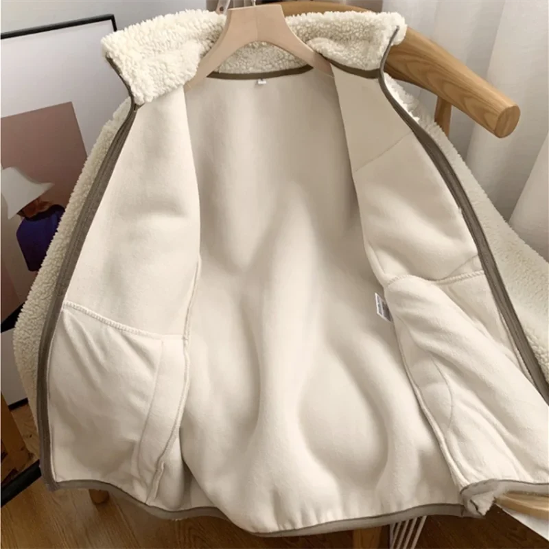 Cream fleece zip-up jacket interior view with high collar and side pockets