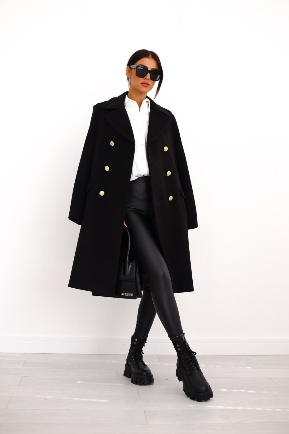 Black long double-breasted overcoat with gold buttons and wide lapels