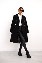 Black long double-breasted overcoat with gold buttons and wide lapels