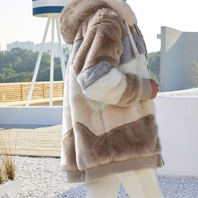 Tan and cream plush hooded vest with patchwork panels, full zipper, and fleece-soft texture
