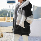 Black and cream plush hooded vest with patchwork blocks, front zipper, and warm sherpa feel