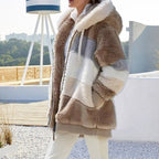 Brown plush hooded vest with cream patchwork panels, front zipper, and fluffy sherpa surface