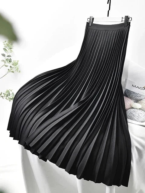 Black women's pleated high-waist A-line maxi skirt with flared hem and waistband