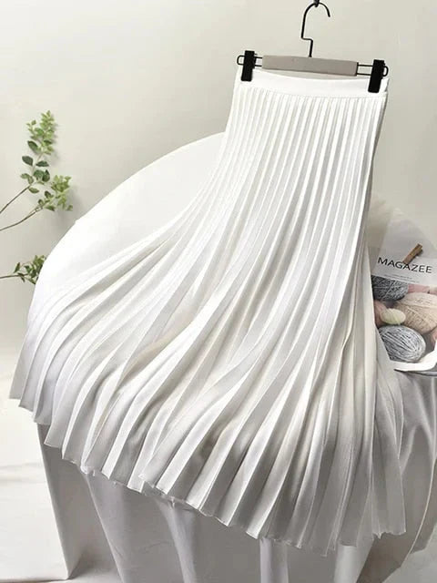White women's pleated high-waist A-line maxi skirt with flared hem and waistband