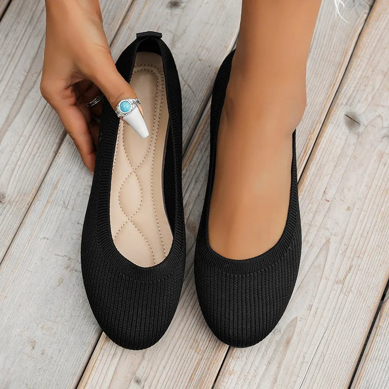 Black stretch knit ballerina flats, showing interior and top opening