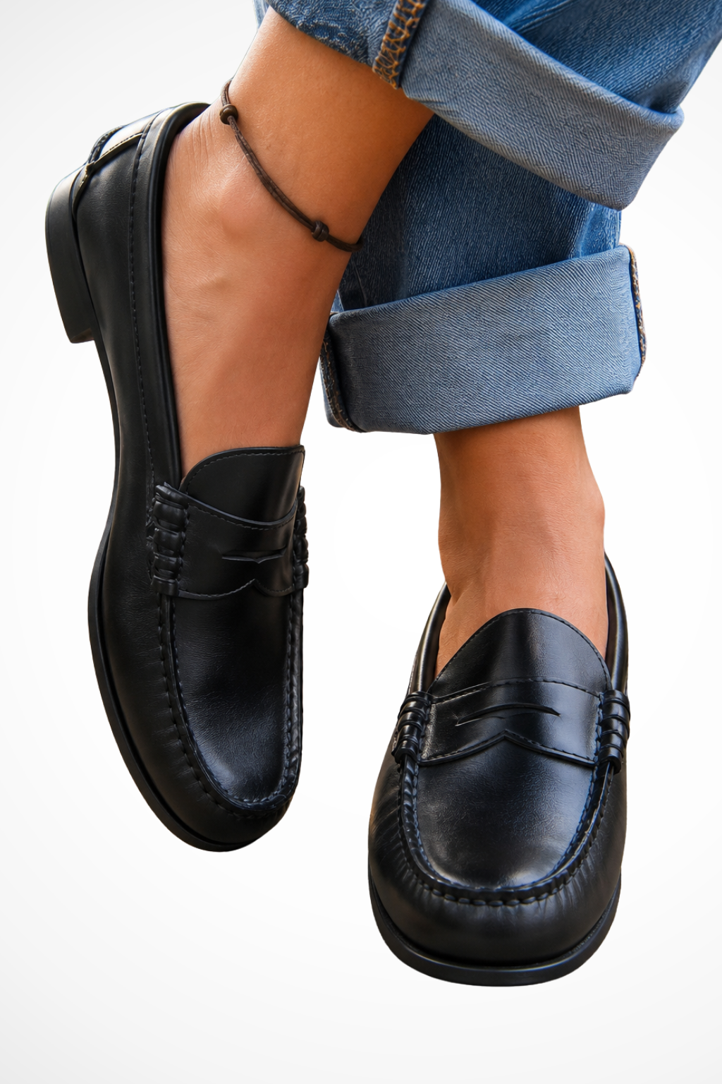 Leather penny strap loafers in black, slip-on with decorative stitch apron and molded sole