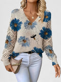 Floral knit cardigan with blue and yellow flower print, V-neck and crochet-style cuffs
