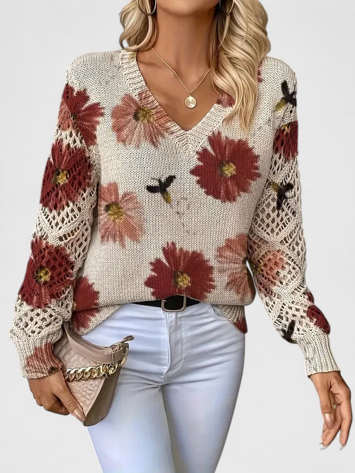 Floral knit cardigan with cream and red flower print, V-neck and crochet-style sleeve panels
