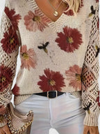 Floral knit cardigan close-up in cream with red flower print, V-neck and textured knit hem